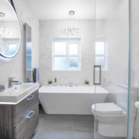 Dansani wall-hung basin unit with LED lighting, back-to-wall freestanding bath, close coupled toilet, concealed smart shower and LED mirror